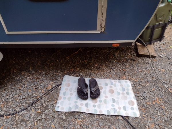 Clean place to step out of the teardrop with shoes that are ok if they get rained on